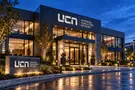 Universal Consulting Network — Exterior silver signage concept mockup