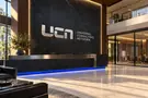 Universal Consulting Network — Reception silver signage concept mockup